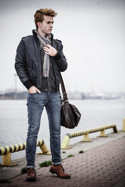 fashion model guy with bag outdoors - Fotó, kép