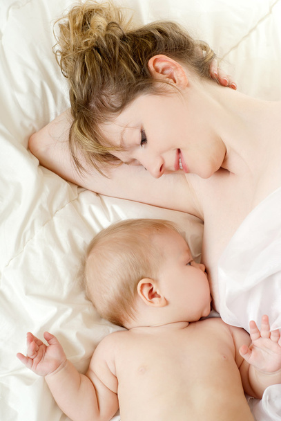 Mother breast feeding her infant - Фото, зображення