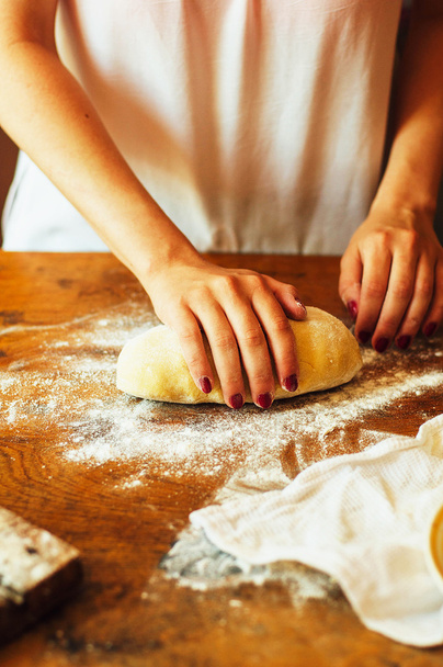 Cooking homemade raspberries  cake.  Woman rolling a pie dough - Fotó, kép