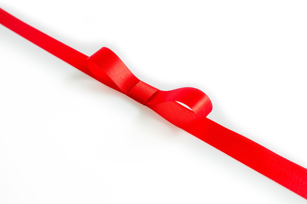 Red ribbon and bow with soft shadow on white background - Photo, Image