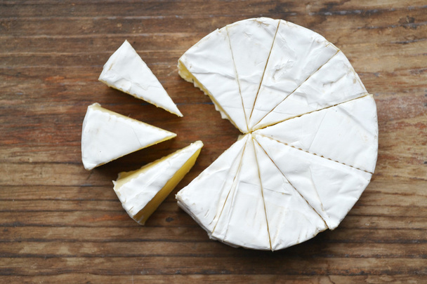 Camembert white creamy cheese on wooden table - Valokuva, kuva
