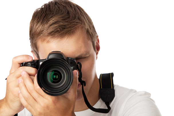 Closeup portrait of a young man taking a picture over white background - Φωτογραφία, εικόνα