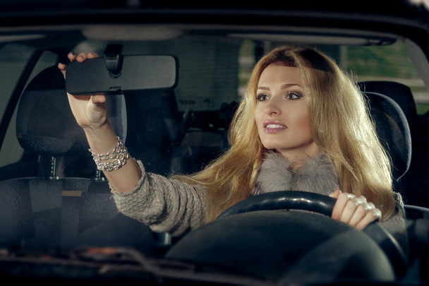 Portret miasta Ładna Blondynka kierowcy w samochodzie. Scen noc - Zdjęcie, obraz