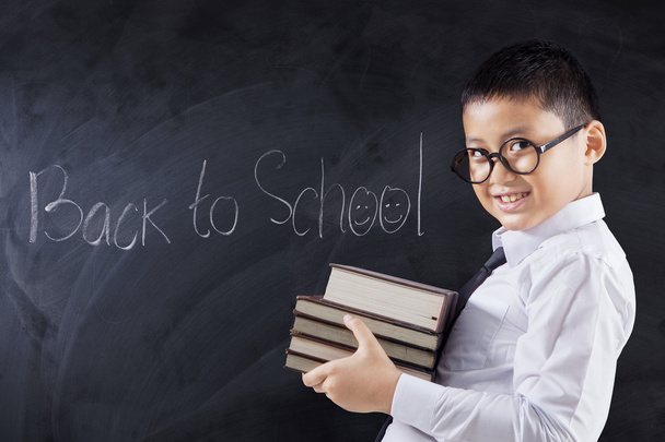 Child with books and text Back to School - Zdjęcie, obraz