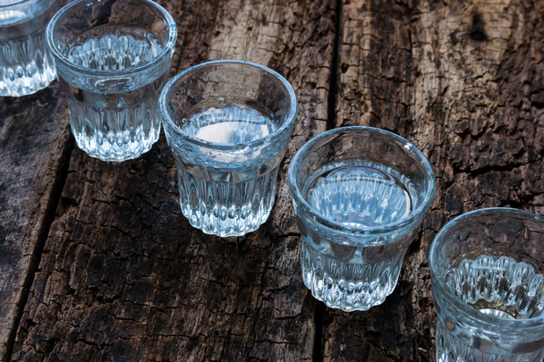shot glasses cold vodka top view on a wooden background - Foto, imagen
