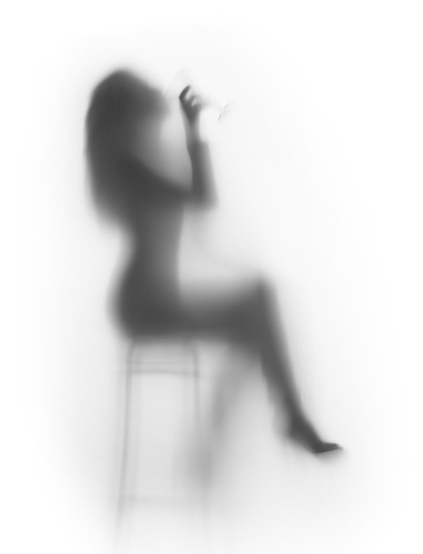 Sexy woman drinks on chair, silhouette - Foto, afbeelding