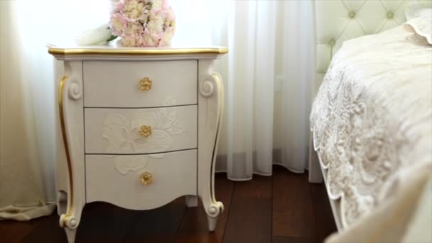 Mooie witte bruiloft bloemen op de witte vintage nachtkastje - Video
