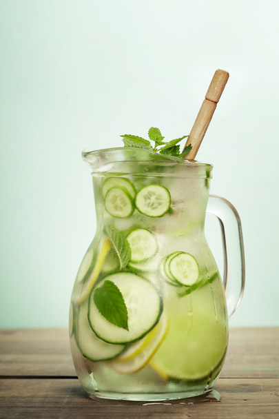 Infused water with cucumber, lemon, lime and mint  - Fotó, kép