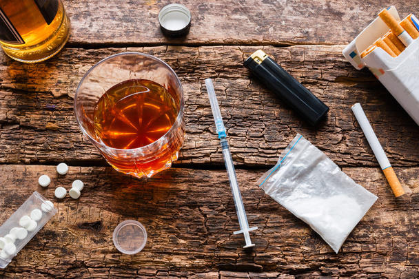 alcohol, cigarettes, drugs, pills on a wooden background - Photo, image