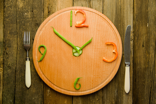 Watch made from vegetables are round cutting Board. - Photo, image