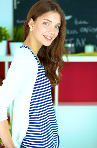 Young woman standing in kitchen at home - Photo, Image