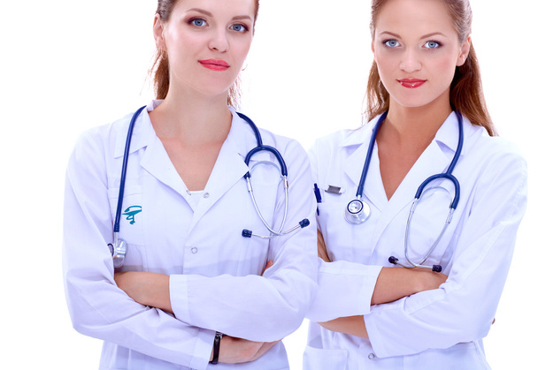 Two woman nurse watching X Ray image, standing in hospital - Fotoğraf, Görsel