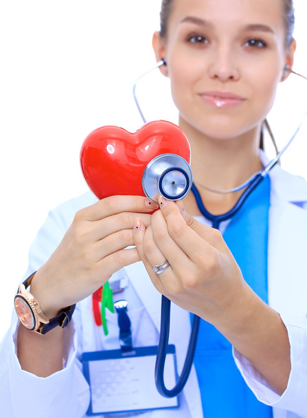 Egy sztetoszkópos orvos, aki vörös szívet vizsgál, fehér alapon izolálva. - Fotó, kép