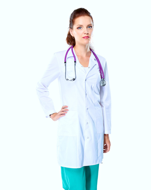Portrait of young woman doctor with white coat standing in hospital - Fotoğraf, Görsel