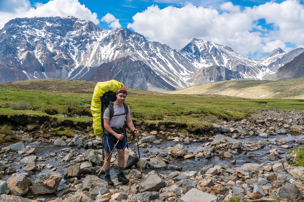 tourist goes to a mountain stream in tunka range - Photo, Image