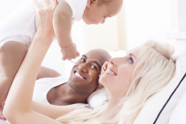 Cheerful interracial family cuddling - Zdjęcie, obraz