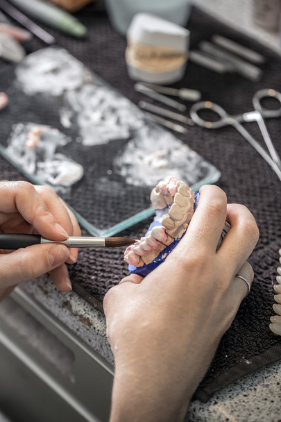 Technician applying ceramics to teeth - Photo, Image
