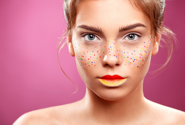 Portrait of bright beautiful girl with art colorful freckles make-up - Fotó, kép