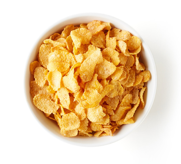 Corn flakes bowl isolated on white, from above - Фото, изображение