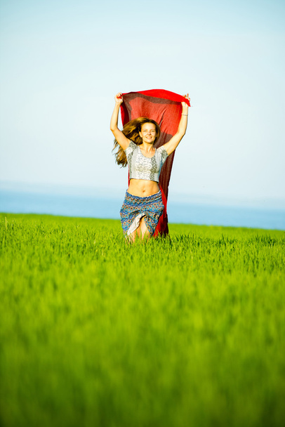 Young happy woman in wheat field with fabric. Summer lifestyle - Photo, Image
