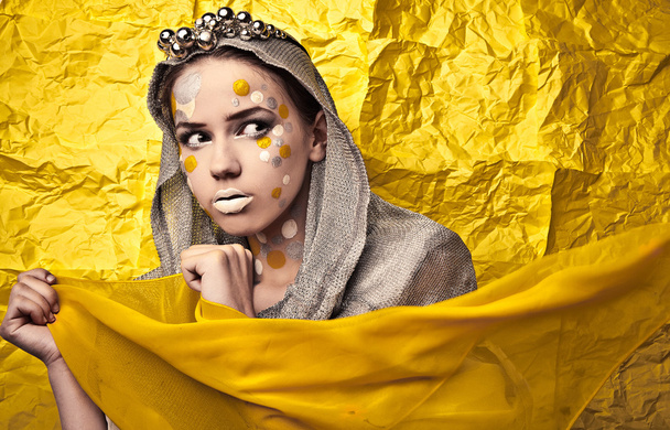 Fashion Beautiful Woman over grunge yellow background. - Photo, Image