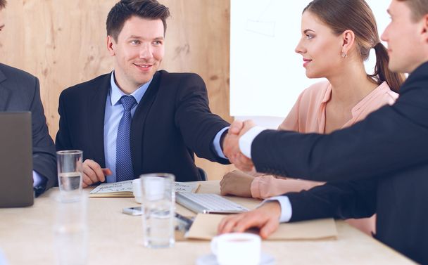 Business people handshake, sitting at the table - Фото, зображення