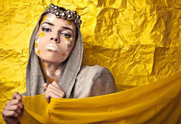 Fashion Beautiful Woman over grunge yellow background. - Photo, image