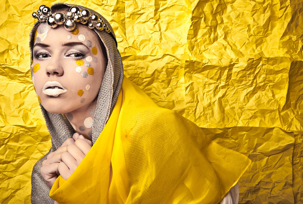 Fashion Beautiful Woman over grunge yellow background. - Fotografie, Obrázek