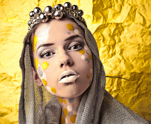 Fashion Beautiful Woman over grunge yellow background. - Фото, изображение