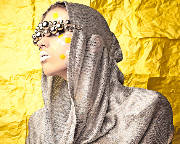 Fashion Beautiful Woman over grunge yellow background. - Fotó, kép