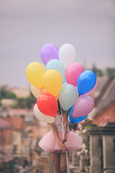 Girl with colorful latex balloons - 写真・画像