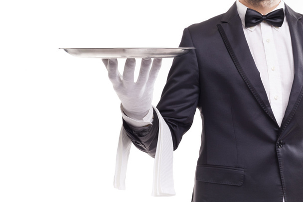 Butler holding a silver tray - Фото, изображение
