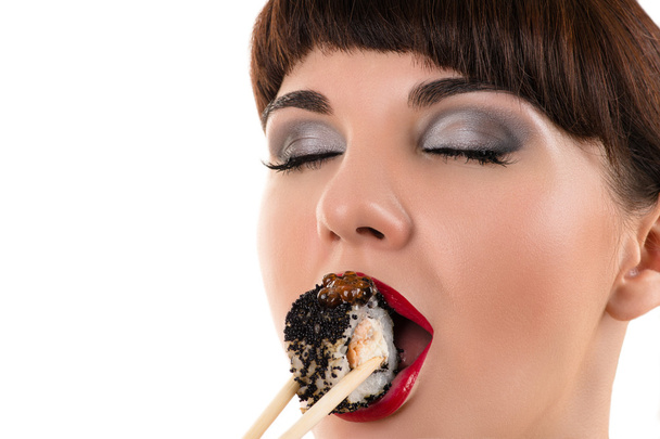 sensual woman eating roll with black caviar - Foto, immagini