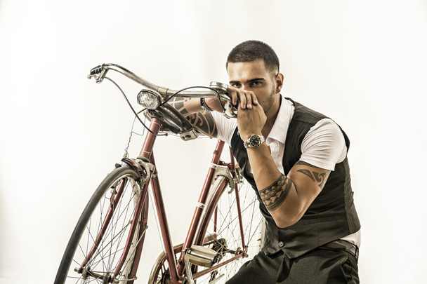 Tattoed elegant man cycling on bicycle - Zdjęcie, obraz