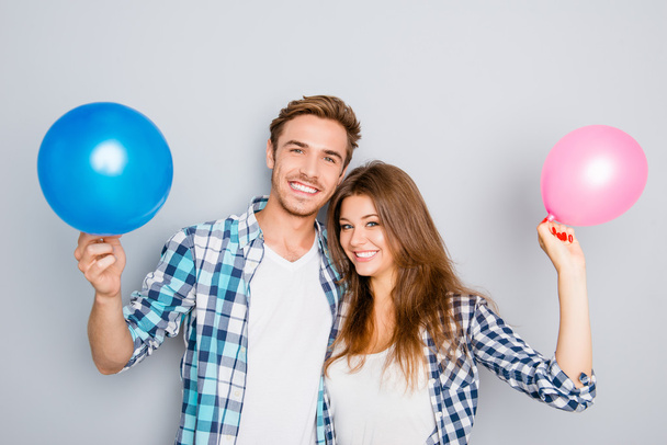 Young happy family holding balloons and celebrating birthday - Photo, Image