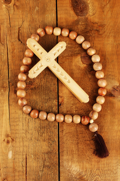 The Wooden rosary beads on wooden background close-up - Фото, изображение