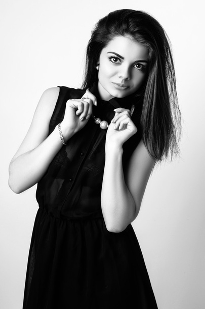 fashion style studio photo of a cute brunette, isolated on white background. Black and white photo - Valokuva, kuva