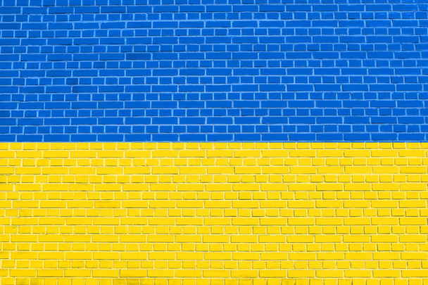 Flag of Ukraine on brick wall texture background - Fotografie, Obrázek