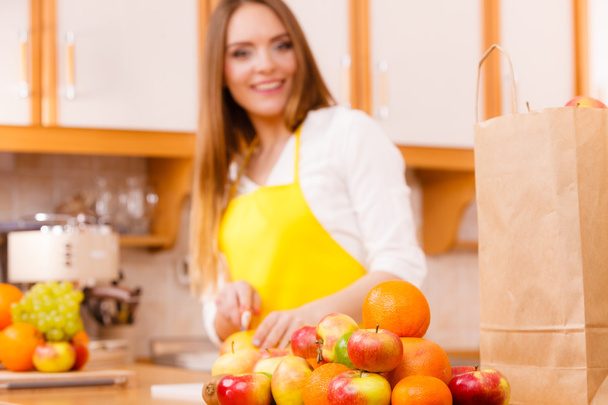 Smiling lady in kitchen. - Фото, изображение