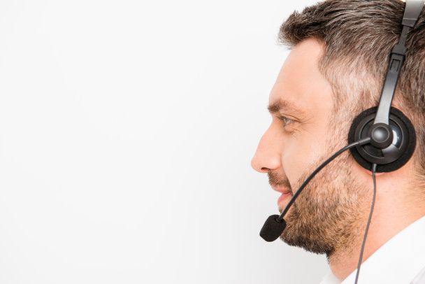 Side view of smiling operator of call center in headphones - Zdjęcie, obraz