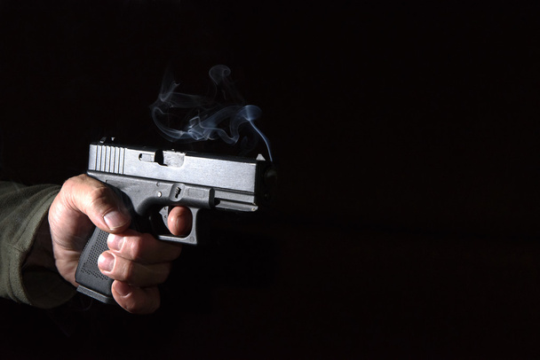 Glock pistol in his hand - Foto, Imagen