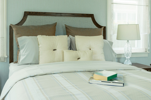 cozy bedroom interior with white pillows and reading lamp on bedside table - Foto, immagini