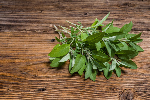 Fresh sage herb on wooden table - Zdjęcie, obraz