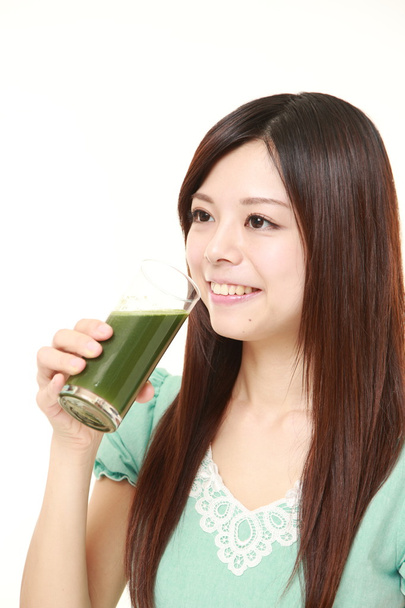 young Japanese woman with green vegetable juice - Foto, immagini