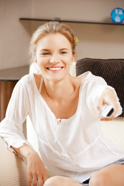 Happy teenage girl with TV remote - Fotoğraf, Görsel