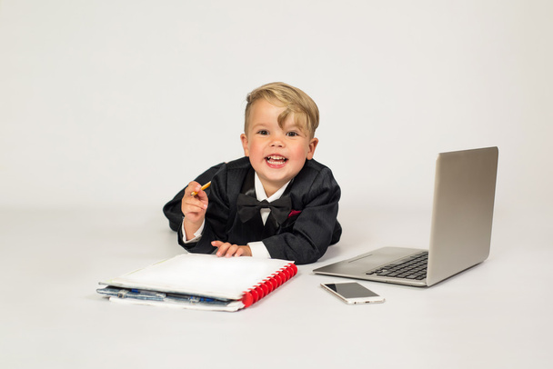 a child in the role of office manager with laptop and phone - Zdjęcie, obraz