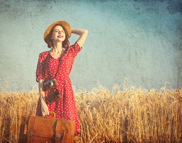 young woman with suitcase and camera - 写真・画像