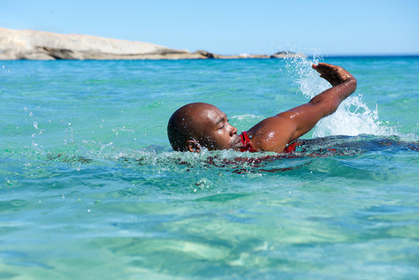 Joven africano nadando en el mar
 - Foto, imagen