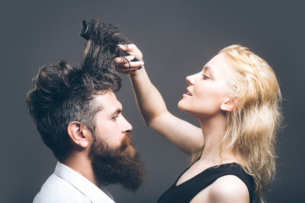 blonde hairdresser combing bearded man - Valokuva, kuva