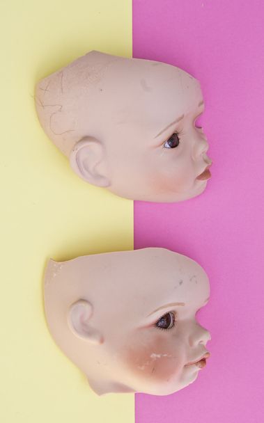 Baby Doll Head, Arms, Face Parts on Yellow and Pink Background - Photo, Image